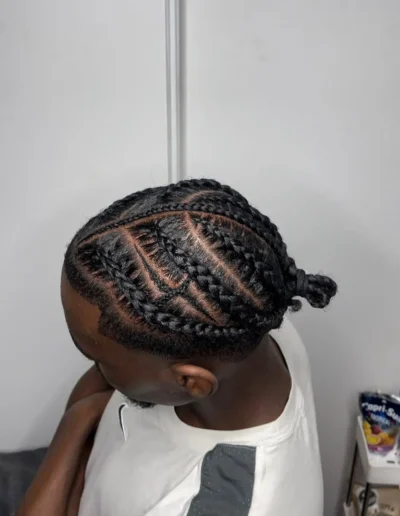 Photo de tresses avec des dessins d'éclairs sur la tête d'un homme noir aux cheveux afro